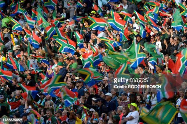 South Africa's supporters wave the national flag as they cheer for their team during the HSBC World Rugby Sevens Series men's final rugby match...