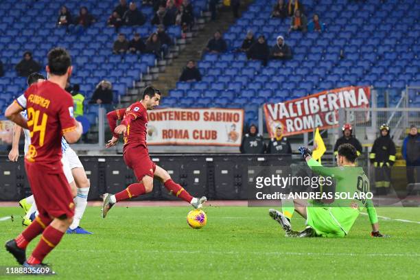 Roma's Armenian midfielder Henrik Mkhitaryan scores his team's third goal past Spal's Albanian goalkeeper Etrit Berisha during the Italian Serie A...