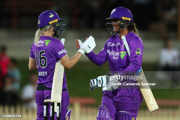 Chloe Tryon of the Hurricanes and Nicola Carey of the Hurricanes celebrate winning the Women's Big Bash League match between the Hobart Hurricanes...