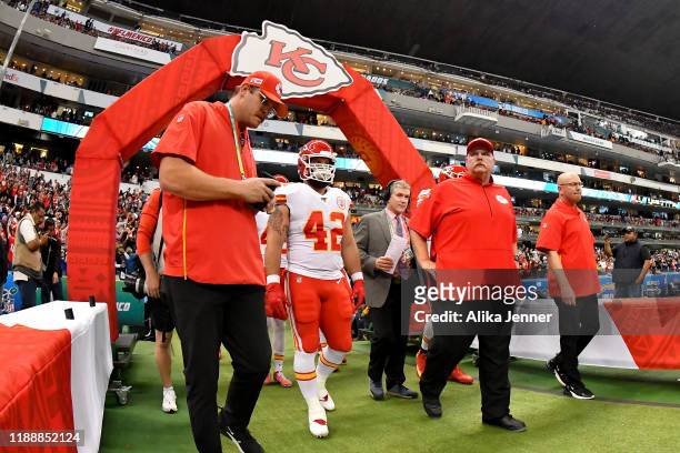Head coach Andy Reid of the Kansas City Chiefs and Anthony Sherman walk out of the team tunnel before an NFL football game against the Los Angeles...