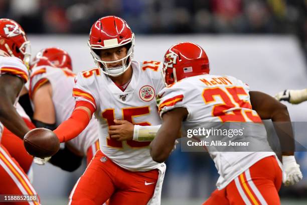 Patrick Mahomes of the Kansas City Chiefs hands the ball off to running back LeSean McCoy during an NFL football game against the Los Angeles...