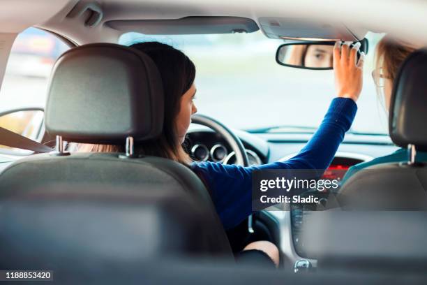 teenager having driving lesson with female instructor - praticando imagens e fotografias de stock