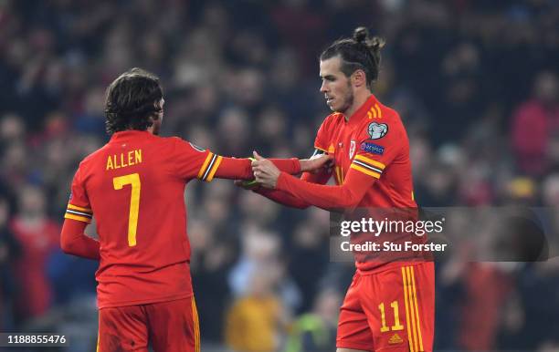 Wales player Gareth Bale passes the captains arm band onto Joe Allen after being substituted during the UEFA Euro 2020 qualifier between Wales and...