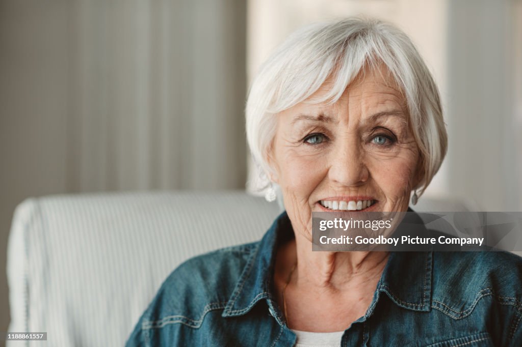 Smiling senior woman relaxing at home in the afternoon