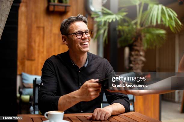 contactless paying - man in a restaurant stock pictures, royalty-free photos & images