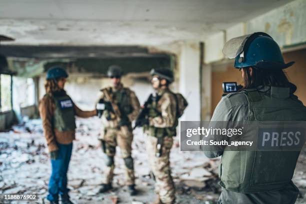 military men giving interview from the war zone - conflict zone stock pictures, royalty-free photos & images