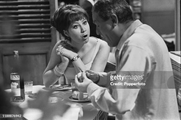 English actress Felicity Kendal, playing the role of Jenny, seated with actor Charles Gray during the shooting of a scene from the Associated...