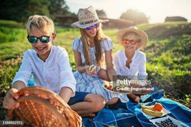 bambini che si godono il picnic nella natura - girls laughing eating sandwich foto e immagini stock