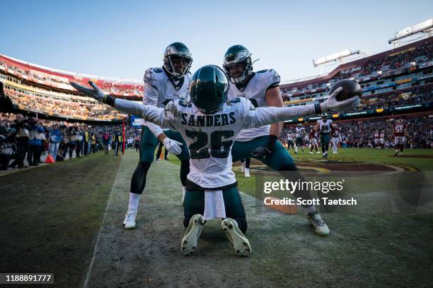 Miles Sanders of the Philadelphia Eagles celebrates with J.J. Arcega-Whiteside and Dallas Goedert after catching a pass for a touchdown against the...