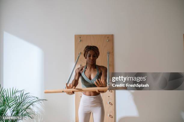 sportswoman doing pilates - gymnastics bar stock pictures, royalty-free photos & images