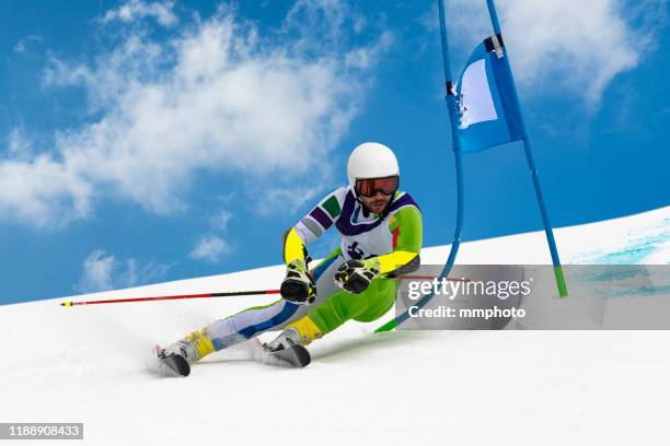 young adult alpine skier at giant slalom practice against the blue sky - alpine skiing stock-fotos und bilder