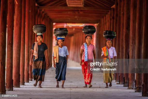 burmese women carrying bowls of rice to the monastery - myanmar food stock pictures, royalty-free photos & images