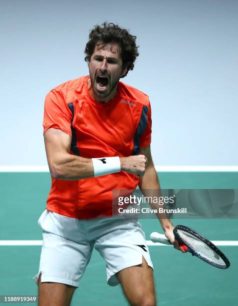 Robin Haase of the Netherlands celebrates match point and victory during his Davis Cup Group Stage match against Daniel Evans of Great Britain during...