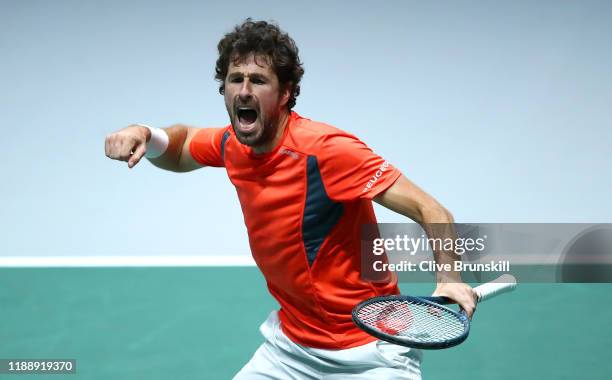 Robin Haase of the Netherlands celebrates match point and victory during his Davis Cup Group Stage match against Daniel Evans of Great Britain during...