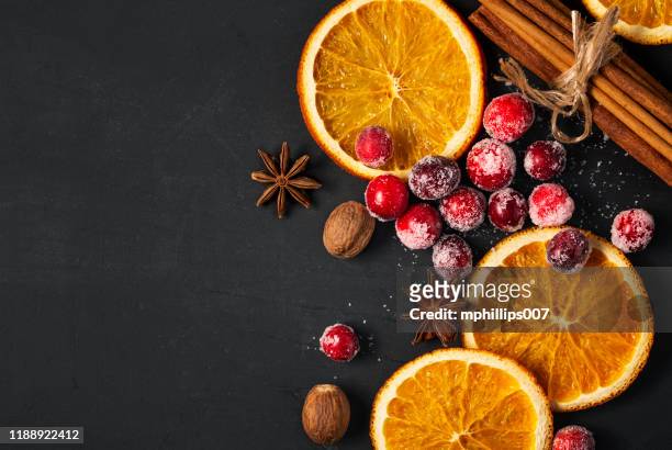 cranberries, dried oranges, and spice for the holidays - orange stock pictures, royalty-free photos & images