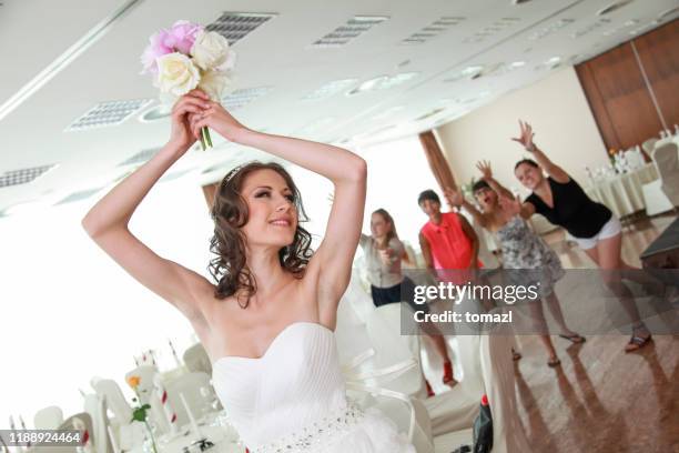bride throwing bouquet - bouquet toss stock pictures, royalty-free photos & images