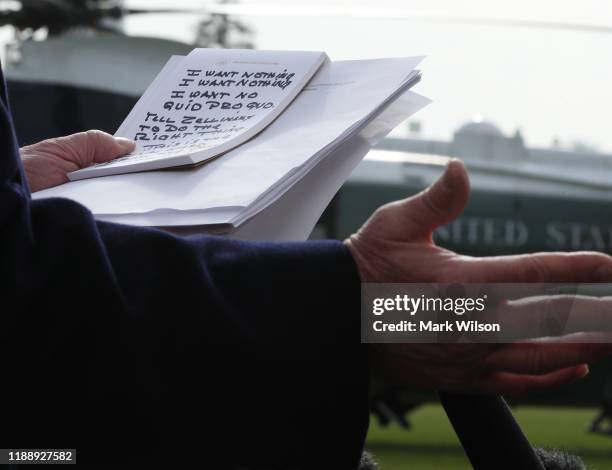 President Donald Trump holds his notes while speaking to the media before departing from the White House on November 20, 2019 in Washington, DC....