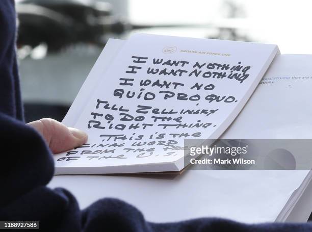 President Donald Trump holds his notes while speaking to the media before departing from the White House on November 20, 2019 in Washington, DC....