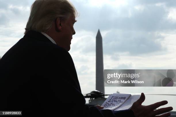 President Donald Trump holds his notes while speaking to the media before departing from the White House on November 20, 2019 in Washington, DC....