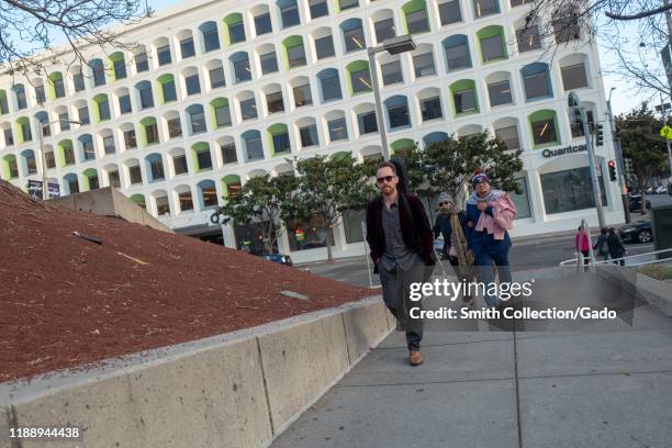 People walk along a pedestrian walkway near Yerba Buena Center in downtown San Francisco, California, November 8, 2019.