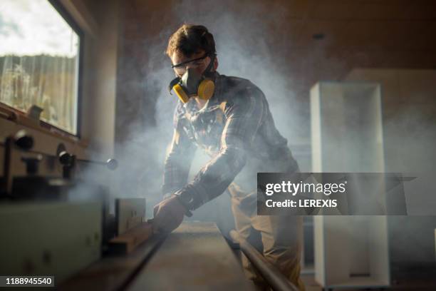 a carpenter works on a woodworking machine - wood worker posing stock-fotos und bilder