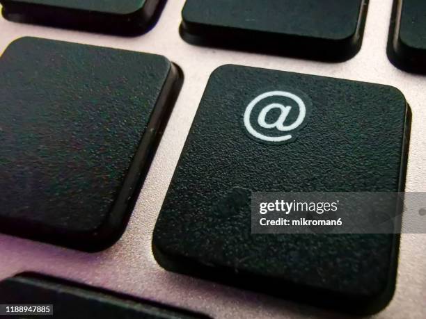 at sign on laptop computer, laptop keyboard - chiocciola simbolo ortografico foto e immagini stock