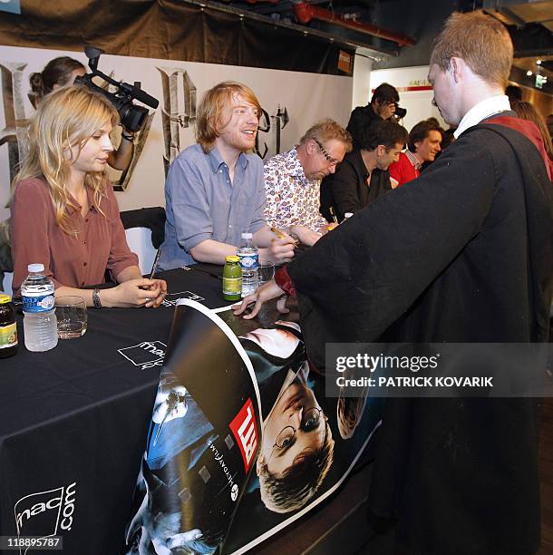 Fan dressed as a wizard holds a poster of Harry Potter during a meeting/dedication with the Harry Potter and the Deathly Hallows Part 2 cast members...