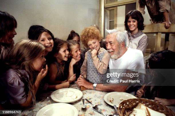 John Huston, director, with Aileen Quinn who played Annie and other child members of the cast of Annie a film released 1982 was an American musical...