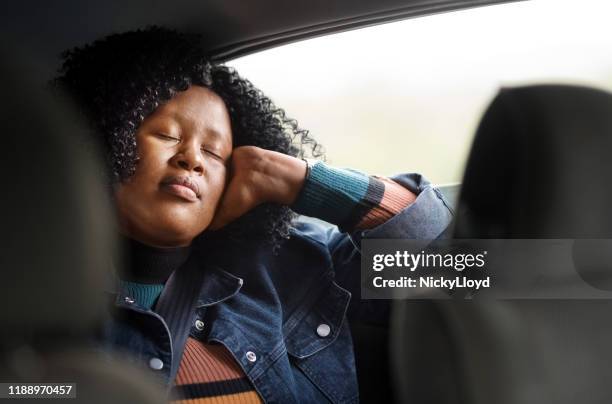 she finds peace on car back seat - sleeping in car stock pictures, royalty-free photos & images