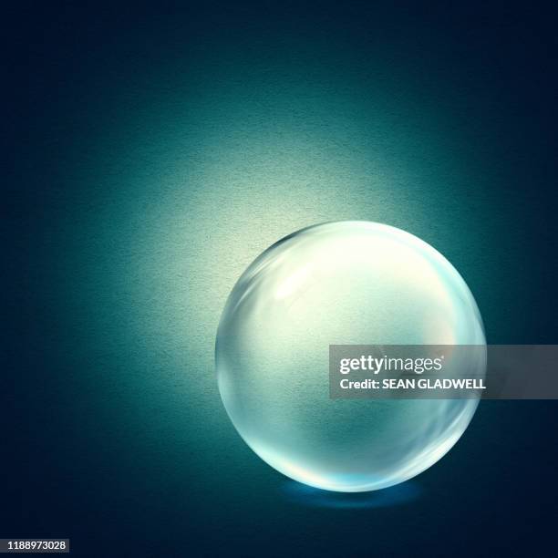 crystal ball on green - glass sphere stock pictures, royalty-free photos & images