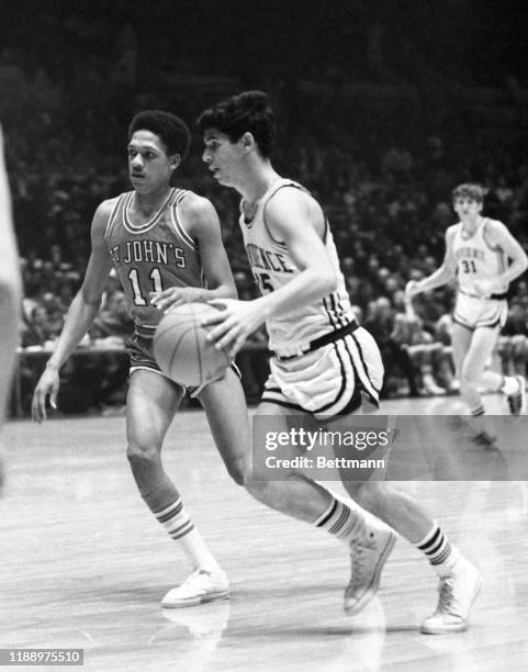 Ernie DiGregorio of Providence dribbling around Ron Rutledge of St. John during Holiday Festival game at Madison Square Garden.
