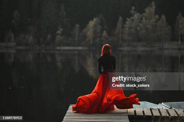 dominant le lac, la reine rousse - red dress photos et images de collection