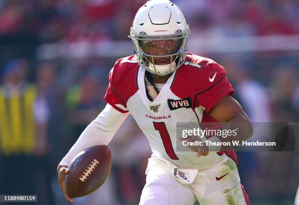 Quarterback Kyler Murray of the Arizona Cardinals scrambles with the football against the San Francisco 49ers during the first half of the NFL game...