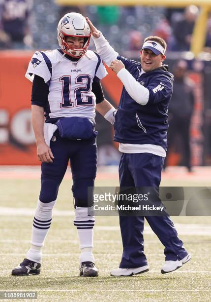 Tom Brady and Josh McDaniels offensive coordinator for the New England Patriots talk before the game against the Cincinnati Bengals at Paul Brown...