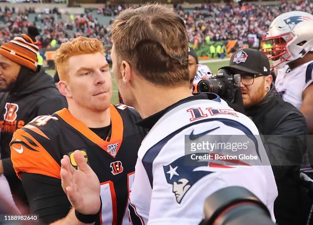 New England Patriots quarterback Tom Brady shakes hands with Cincinnati Bengals quarterback Andy Dalton after the Patriots defeated the Bengals...