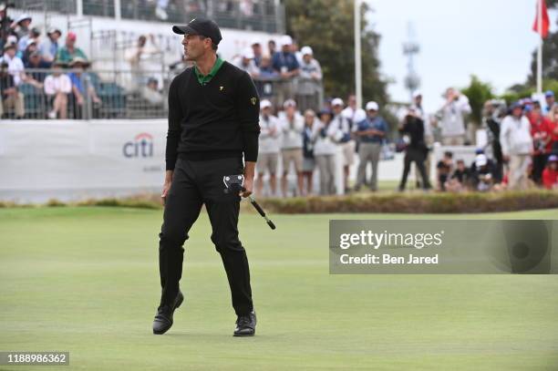 International Team's Adam Scott reacts to missing a putt during the final round singles matches at the Presidents Cup at The Royal Melbourne Golf...