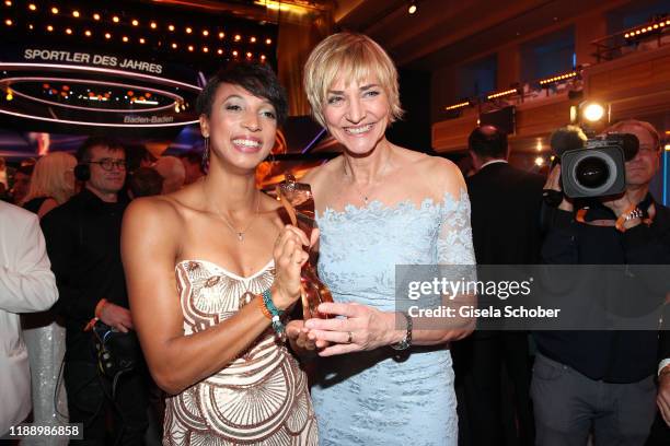 Long jump gold medalist Malaika Mihambo with award and former long jumper Heike Drechsler during the 'Sportler des Jahres 2019' Gala at Kurhaus...