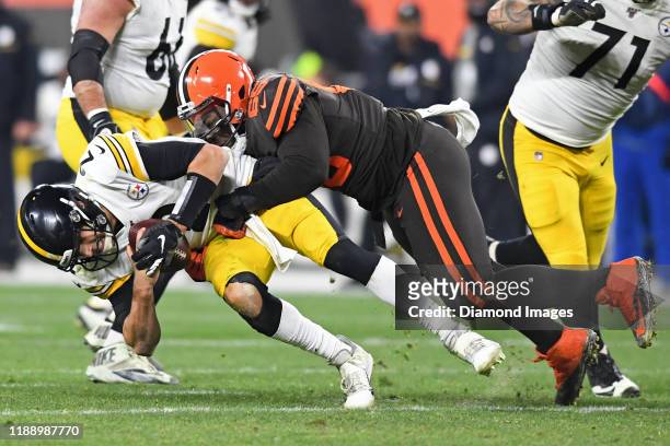 Defensive tackle Larry Ogunjobi of the Cleveland Browns sacks quarterback Mason Rudolph of the Pittsburgh Steelers in the fourth quarter of a game on...