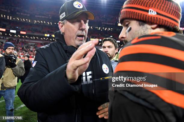 Defensive coordinator Keith Butler of the Pittsburgh Steelers talks with quarterback Baker Mayfield of the Cleveland Browns after a game on November...