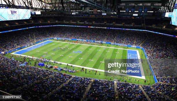 Lions and Buccaneers players wait on the field between plays during the second half of an NFL football game against the Tampa Bay Buccaneers in...