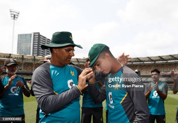 Naseem Shah of Pakistan reacts after receiving his test cap from Waqar Younis ahead of his debut during day one of the 1st Domain Test between...