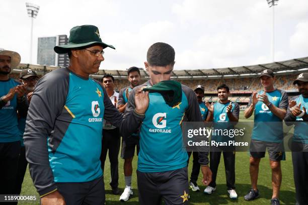 Naseem Shah of Pakistan reacts after receiving his test cap from Waqar Younis ahead of his debut during day one of the 1st Domain Test between...