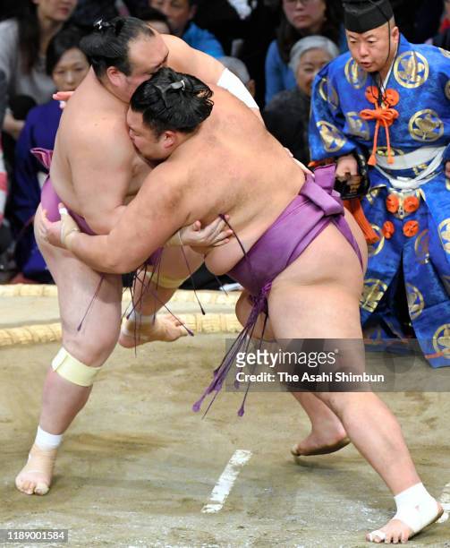 Komusubi Asanoyama pushes Takarafuji out of the ring to win on day eleven of the Grand Sumo Kyushu Tournament at the Fukuoka Convention Centre on...