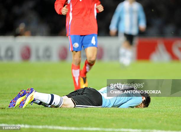 Argentine forward Lionel Messi lies on the ground during a 2011 Copa America Group A first round football match against Costa Rica held at the Mario...
