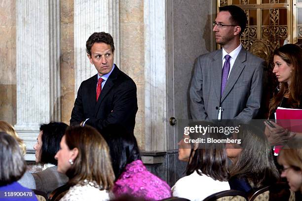 Timothy Geithner, U.S. Treasury secretary, left, waits to speak at the Women in Finance Symposium at the Treasury Department in Washington, D.C.,...