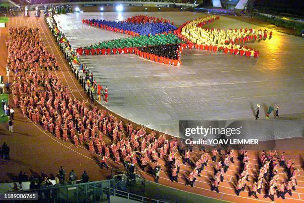 The South African team walks into the Johannesburg stadium while hundreds of children form the logo of the games, 10 September 1999, during the...