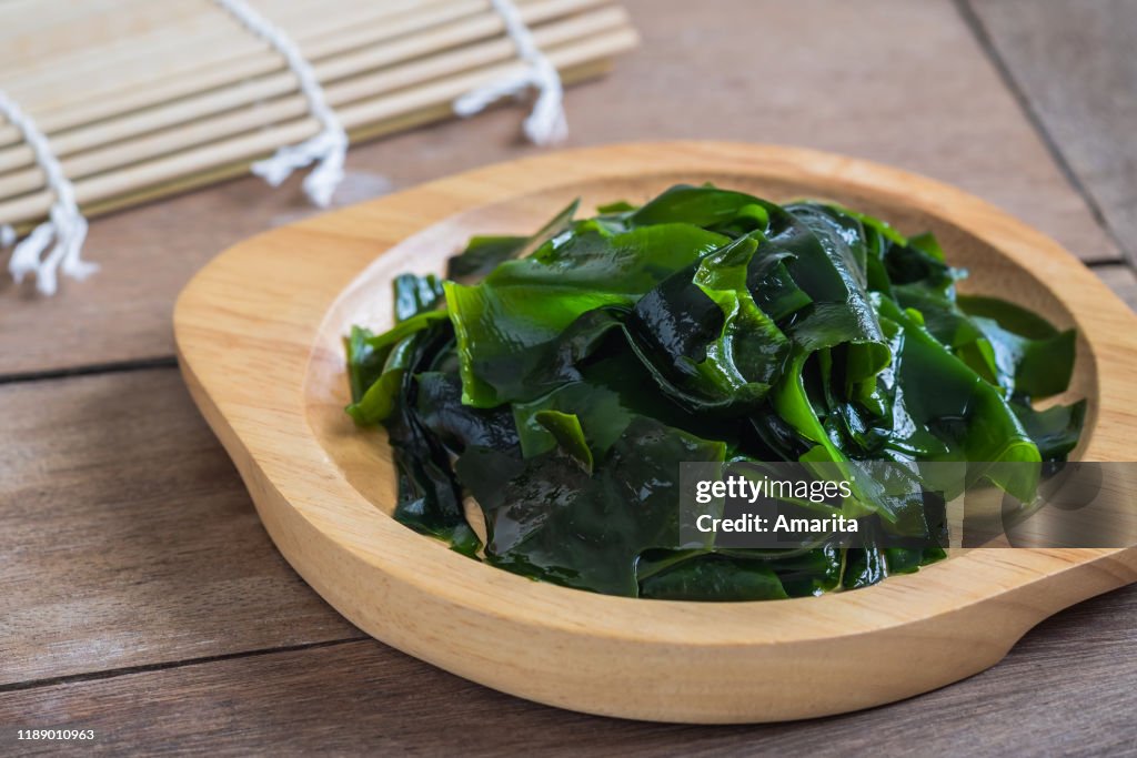 Wakame seaweed on wooden plate