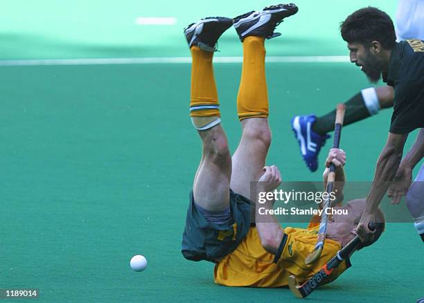 Daniel Sproule of Australia tuble after a challenge by Tariq Imran of Pakistan at a third placing playoff match during the Sultan Azlan Shah Cup...