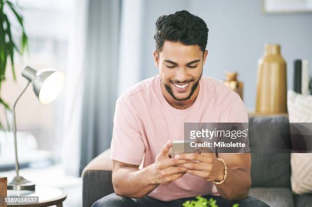 let's test drive this new wifi - young man relaxing on sofa stock pictures, royalty-free photos & images