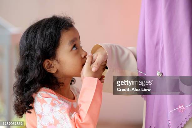 portrait of young muslim twin sisters! - kissing hand stock pictures, royalty-free photos & images